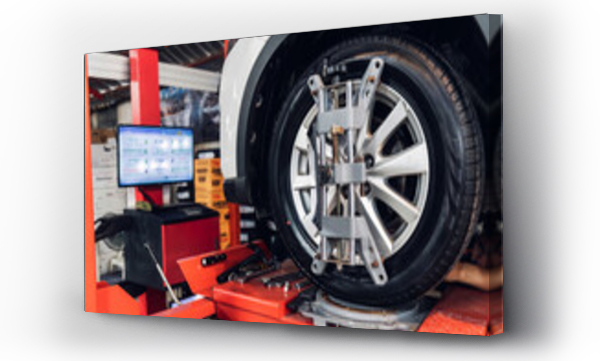 Wizualizacja Obrazu : #1061027560 Car wheel centering machine adjustment. Auto service mechanic installing wheel alignment sensor on tire during vehicle suspension alignment adjustment