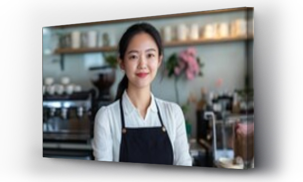 Wizualizacja Obrazu : #1142280334 A woman wearing a black apron stands in front of a counter with a smile on her face