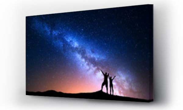 Wizualizacja Obrazu : #120563008 Milky Way. Colorful night sky with stars and silhouette of standing happy man and woman with raised  up arms on the hill. Blue milky way with people on the mountain. Background with beautiful universe
