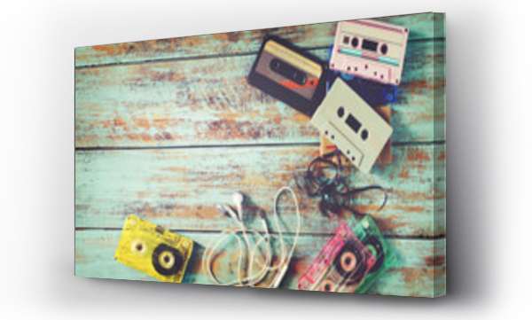 Wizualizacja Obrazu : #126091314 Top view (above) shot of retro tape cassette with earphone on wood table - vintage color effect styles.