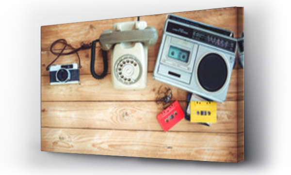 Top view bohater nagłówek - retro technologii radia kasety magnetofonowej z retro kasety magnetofonowej, rocznika telefon i aparat fotograficzny film na stole drewnianym. Vintage stylów efektów kolorystycznych.