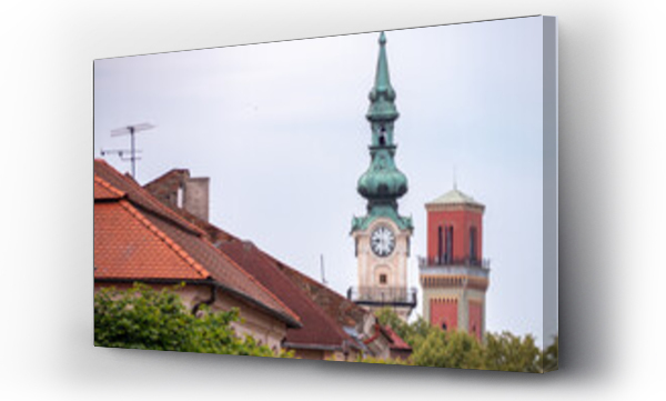 Wizualizacja Obrazu : #1598136465 Clock tower of Ke?marok Town Hall and red tower of the Evangelical Church rise above rooftops in the historic center of Ke?marok, Slovakia.