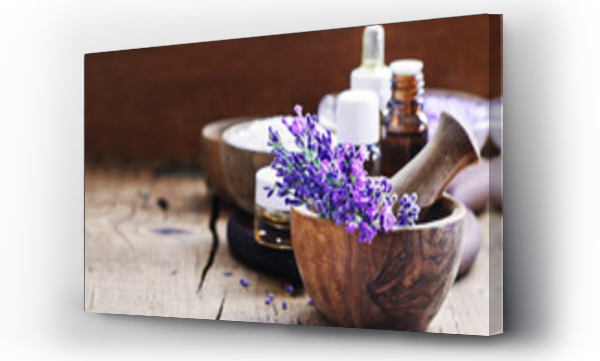 Wizualizacja Obrazu : #160798997 Lavender spa , bunch of lavender flowers , essential oil and salt on a rustic wooden background.