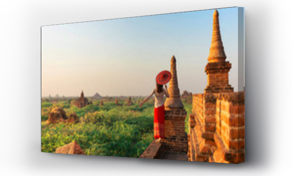 Wizualizacja Obrazu : #162525655 A girl with a traditional Burmese umbrella relaxing in an ancient temple during sunset, Bagan,Myanmar.Ancient temples in Bagan in sunny sunset.Young traveller enjoying a looking at Buddhist stupas.