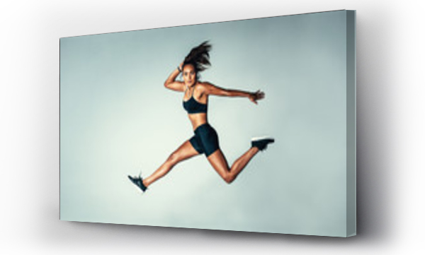 Wizualizacja Obrazu : #163752958 Female model in sports wear jumping in air