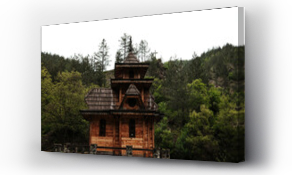 Wizualizacja Obrazu : #1711107762 Front view of the Saint Andrew chapel surrounded by forest and cross in the distance in Mokra Gora, Serbia