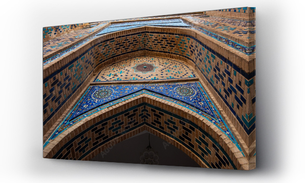 Wizualizacja Obrazu : #1726871875 Ornate Islamic architecture with blue mosaic tile work and detailed geometric patterns on a brick facade, photographed from below within the historical necropolis complex in Samarkand, Uzbekistan.