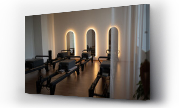 Wizualizacja Obrazu : #1767805450 Serene pilates space, peaceful pilates environment featuring soft lighting and organized reformers