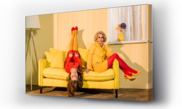 Wizualizacja Obrazu : #200350171 retro styled beautiful girls in red and yellow dresses on sofa at home