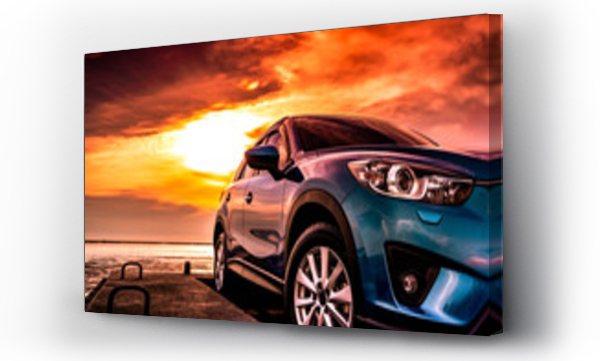 Wizualizacja Obrazu : #207384928 Blue compact SUV car with sport, modern, and luxury design parked on concrete road by the sea at sunset. Front view of beautiful hybrid car. Driving with confidence. Travel on vacation at the beach.