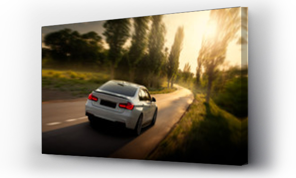 Wizualizacja Obrazu : #213989519 Biały samochód jedzie po pustej wiejskiej asfaltowej drodze przy zachodzie słońca
