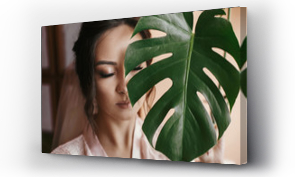 Wizualizacja Obrazu : #214390027 gorgeous bride portrait with monstera leaf. beautiful woman getting ready for wedding, holding green leaf and posing. skin care and make-up. sensual moment