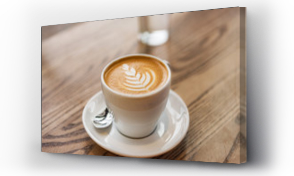 Wizualizacja Obrazu : #219364830 Latte art in cappuccino coffee cup at cafe table. Closeup of rosetta flower drawing in foam.