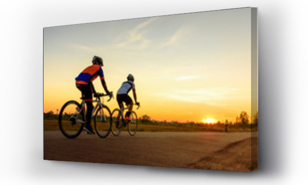 Wizualizacja Obrazu : #240490512 Men ride bicycles on the road with beautiful colorful sunset sky. Sport and active life concept.