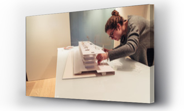 Wizualizacja Obrazu : #243651566 Female architect working on architecture model on table
