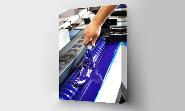 Wizualizacja Obrazu : #255917274 Drukarnia. Drukarz dolewa niebiesk? farb? drukarsk? do maszyny.