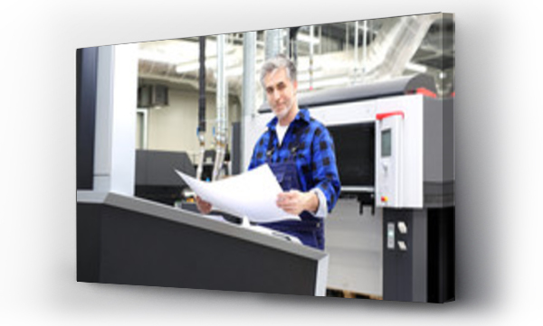 Drukarnia. U?miechni?ty drukarz sprawdza arkusz