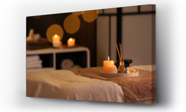 Wizualizacja Obrazu : #263932128 Burning candles and aromatic reed freshener on table in spa salon, space for text