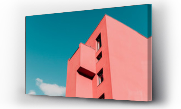 Widok z dołu na różowy nowoczesny dom i niebo. Vintage pastelowe kolory, minimalistyczna koncepcja.