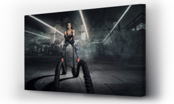 Wizualizacja Obrazu : #272405273 Sport backgrounds. Powerful attractive muscular woman fitness trainer do battle workout with ropes at the gym.