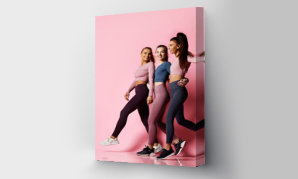 Wizualizacja Obrazu : #273859935 Good shaped sport girls friends in blue, grey, brown Sportwear walk together, talk and laugh. Fitness and yoga girls on pink background