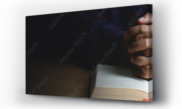 Wizualizacja Obrazu : #282254530 Hands of praying young man and Bible on a wooden table.