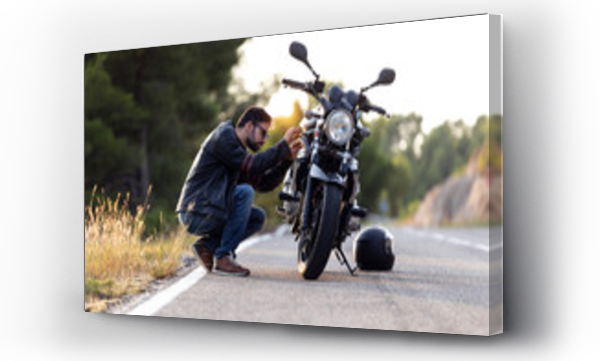 Wizualizacja Obrazu : #295062874 Young man biker checking his motorbike before driving it on the road.
