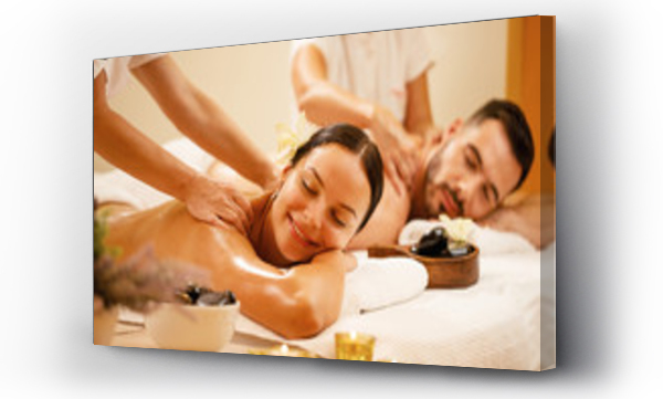 Wizualizacja Obrazu : #298236425 Happy couple enjoying a day at spa while having back massage.