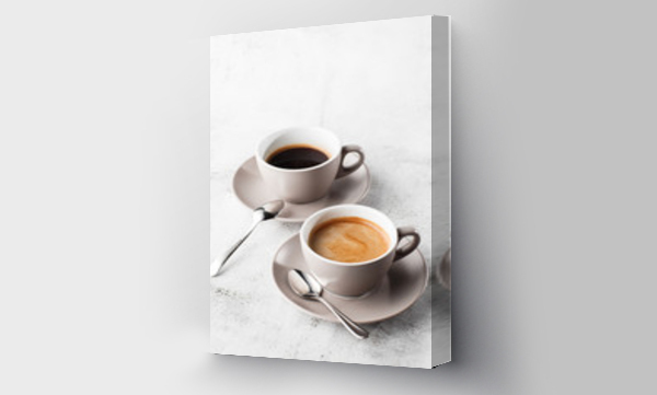 Wizualizacja Obrazu : #302794719 Two white cups of hot black coffee with milk isolated on bright marble background. Overhead view, copy space. Advertising for cafe menu. Coffee shop menu. Vertical photo.