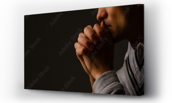 Wizualizacja Obrazu : #304761805 Religious young man praying to God on dark background, black and white effect