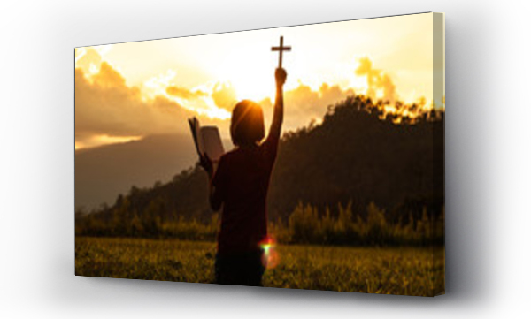 Wizualizacja Obrazu : #311495207 Silhouette of woman praying with cross in nature sunrise background, Crucifix, Symbol of Faith. Christian life crisis prayer to god.