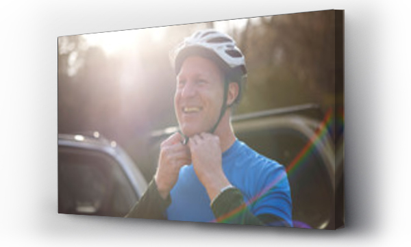 Wizualizacja Obrazu : #315233129 Portrait smiling man fastening bike helmet