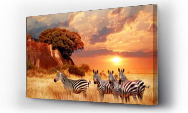 Zebry na afrykańskiej sawannie na tle pięknego zachodu słońca. Park Narodowy Serengeti. Tanzania. Afryka.