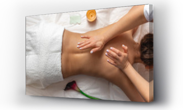 Wizualizacja Obrazu : #326053177 top view professional masseuse performing with hand back massage to young woman client in wellness spa center, beauty photo concept and atmosphere of calm and relaxation