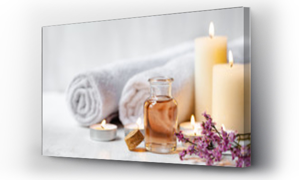 Wizualizacja Obrazu : #327551030 Concept of spa treatment in salon. Natural organic oil, towel, candles as decor. Atmosphere of relax, serenity and pleasure. Anti-stress and detox procedure. Luxury lifestyle. White wooden background