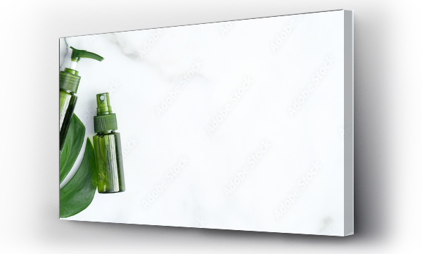Wizualizacja Obrazu : #334659020 Green cosmetic bottles with monstera tropical plant leaf on marble background. Flat lay, top view, copy space. Natural organic products, beauty and SPA concept