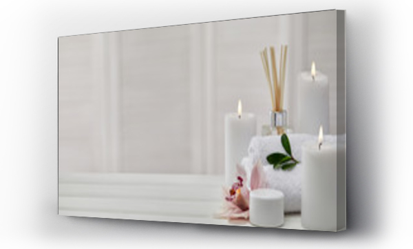 Wizualizacja Obrazu : #334969769 Spa products with aromatic candles, orchid flower and towel on white wooden table. Beauty spa treatment and relax concept. copy space
