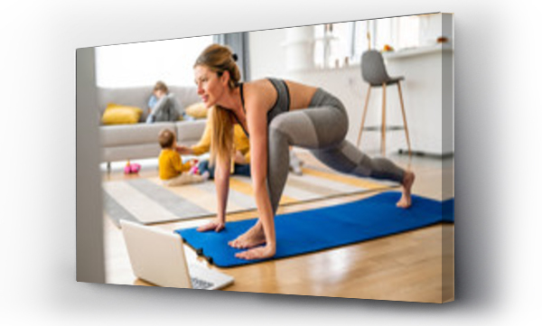 Wizualizacja Obrazu : #346134970 Young woman is exercising yoga at home. Fitness, workout, healthy living and diet concept.