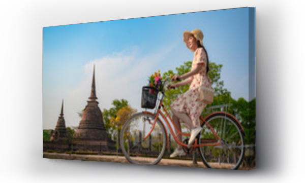 Wizualizacja Obrazu : #347088879 Woman traveller riding retro bicycle enjoy sightseeing takes a picture photo and looks at the buddhist statue with gentle pay respect pray to buddhist statue in historic park of Thailand