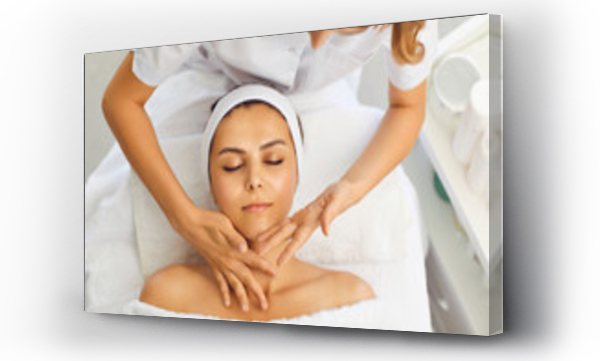 Wizualizacja Obrazu : #371862794 Beautician makes a facial massage to a woman in a spa salon. Woman receiving face protection treatment procedures