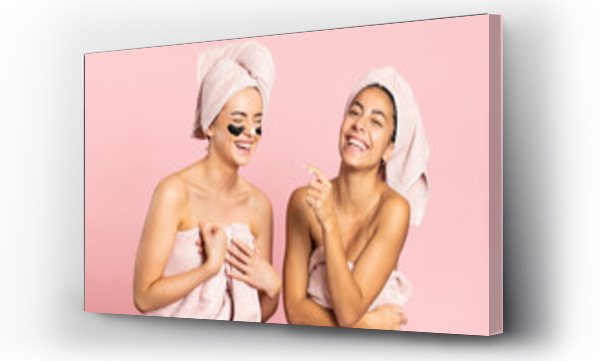 Wizualizacja Obrazu : #380745237 Cheerful young diverse females friend wrapped in bath towels smiling happily while enjoying spa charcoal treatment against pink background
