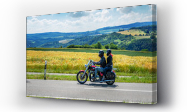 Wizualizacja Obrazu : #389092699 Couple on a motorcycle riding through german summer landscape