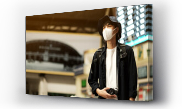 Wizualizacja Obrazu : #389899811 Asian travelers men and camera in train station with medical face mask to protection the Covid-19, new normal lifestyle