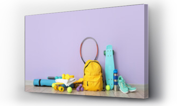 Wizualizacja Obrazu : #391443106 Set of sport equipment on floor near color wall