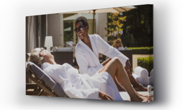 Wizualizacja Obrazu : #396820644 Happy senior women friends relaxing in spa robes on sunny hotel patio