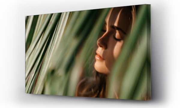 Wizualizacja Obrazu : #397528386 portrait of tender woman looking out of palm leaf Bali Indonesia