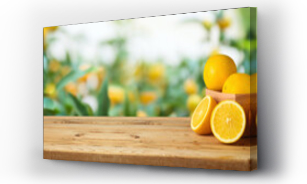 Wizualizacja Obrazu : #403652329 Oranges fruit on wooden table over blurred green tree background