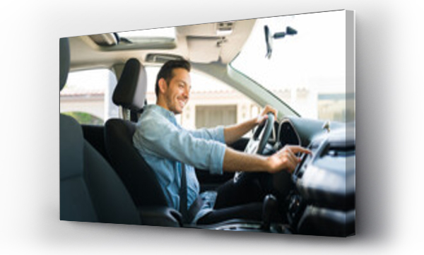 Wizualizacja Obrazu : #415370995 Attractive male driver using the GPS navigation map on the car