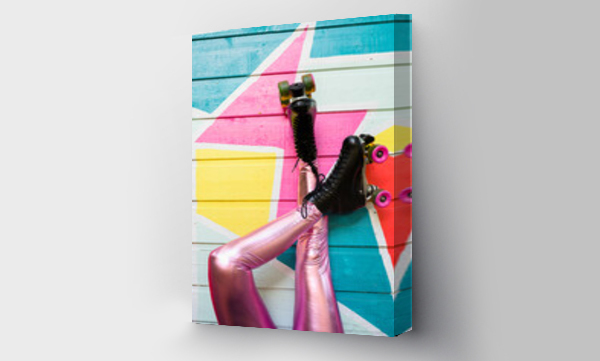 Wizualizacja Obrazu : #420605138 Legs wearing Roller Skates Resting Against Colorful Wall