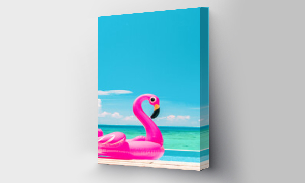 Wizualizacja Obrazu : #433153562 Summer vacation fun vertical crop of pink flamingo swimming pool toy float floating on infinity luxury resort pool with blue ocean background.